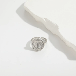 Detail shot of silver copper ring with micro-set heart zircon on plaster decor