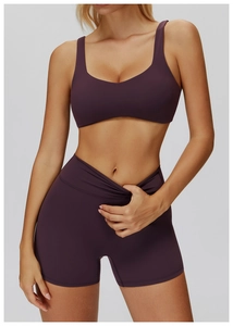 Close-up of plum purple yoga set featuring V-shape cross waistband on high-waist shorts
