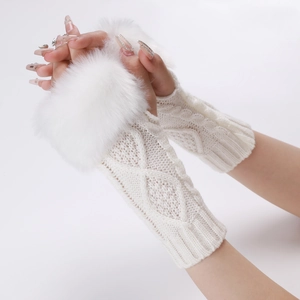 Macro shot of white cable knit arm warmers with fluffy faux fur cuffs and fingerless design