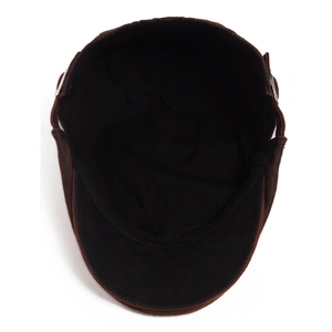 Interior view of vintage brown washed flat cap with black lining and metal buckle