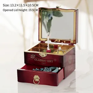 Vintage ballerina music box with mahogany finish, golden accents and a rotating dancer