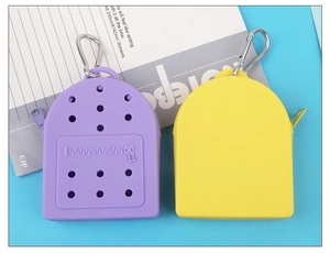 Detail of purple and yellow silicone coin purses with breathable holes and metal carabiner