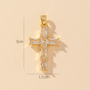Macro detail of a 3cm gold-plated cross pendant with emerald-cut cubic zirconia