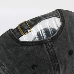 Detail of vintage washed grey cotton baseball cap with adjustable copper metal buckle