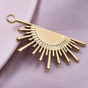 Macro shot of 18k gold plated stainless steel sunflower petal charm with radial texture