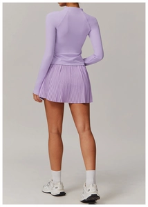Back view of breathable lavender sports set featuring long sleeve top and pleated skirt