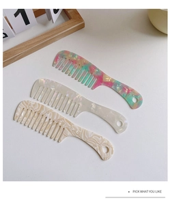 Detailed close-up of marble pattern acetate combs with anti-static teeth and handle