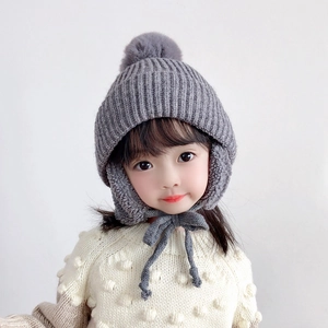 Kids warm gray knitted earflap hat with pompom and chin straps for cold winter