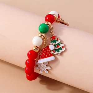 Detail view of festive Christmas beaded bracelet with colorful charms on display stand