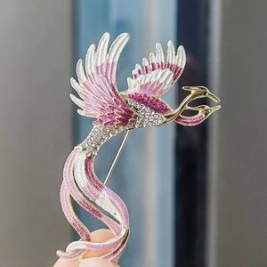 Elegant phoenix brooch with pink and white enamel wings and sparkling rhinestones