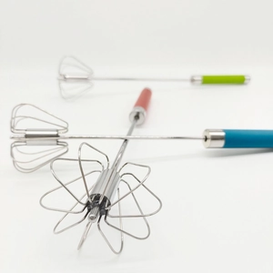 Macro detail of semi-automatic stainless steel whisks with colorful ergonomic handles