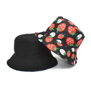 Detail view of black bucket hat with strawberry embroidery and reversible fabric textures