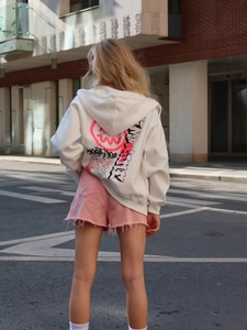 Oversized white zip-up hoodie with pink graffiti smile print back view for streetwear style