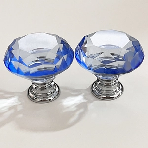 Close-up of deep blue faceted crystal drawer knobs with silver aluminum bases
