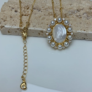 Vintage gold necklace with Virgin Mary shell pendant surrounded by pearls and rhinestones