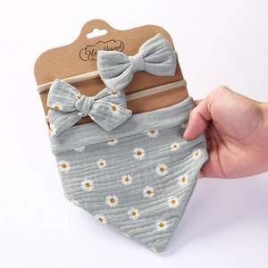 Grey cotton muslin baby bib and headband set featuring delicate white daisy patterns