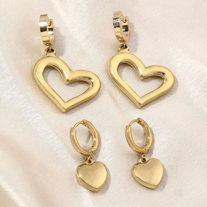 Elegant gold heart earrings set featuring hollow and solid heart charms on satin