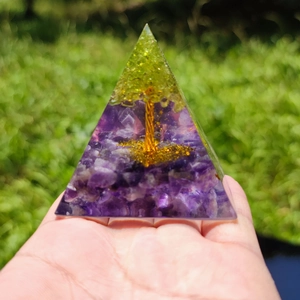 Detailed close-up of Orgone pyramid with amethyst base and copper Tree of Life in resin