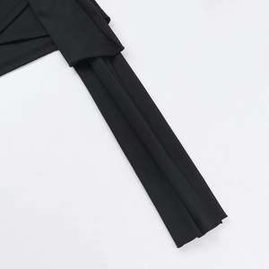 Close-up of black fabric texture showing the high-quality knit material and elegant drape