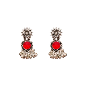 Vintage silver flower Jhumka earrings with red gemstones and bell charms on white background