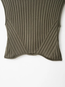Detail of olive green knit vest featuring textured ribbing and curved bottom hemline