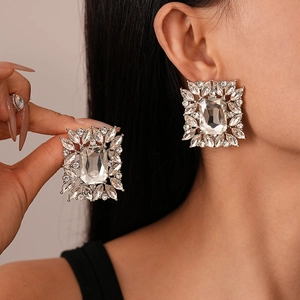 Baroque style silver square earrings with sparkling crystals shown worn on ear