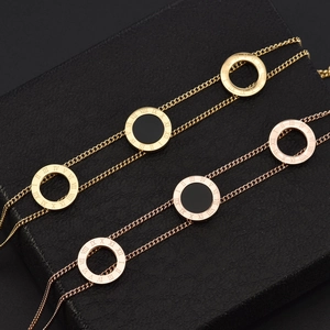 Double-layered 18K gold plated Roman numeral bangle with black enamel shell accents