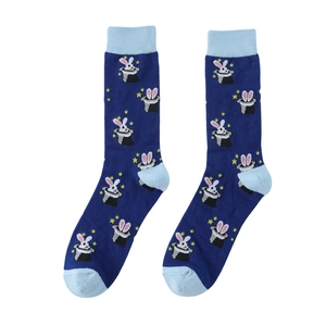 Detail of blue cotton socks with rabbit magic hat and star pattern embroidery