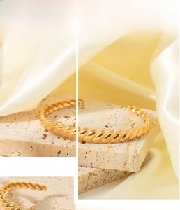 Detailed view of 18K gold plated C-shaped cuff bracelet with twisted rope texture