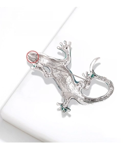 Detail of silver lizard brooch with dual-function pendant loop on geometric stone