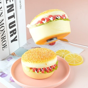 Realistic artificial burger magnet model with sesame bun and lettuce on a pink plate