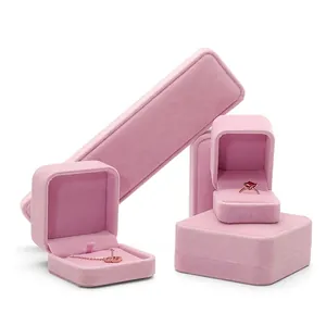 Set of pink velvet jewelry boxes for necklaces, bracelets and rings on white background