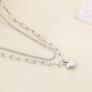 Double-layered stainless steel necklace featuring a heart pendant and paperclip bead chain