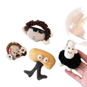 Handmade plush cartoon brooches featuring eccentric human figures and animal designs