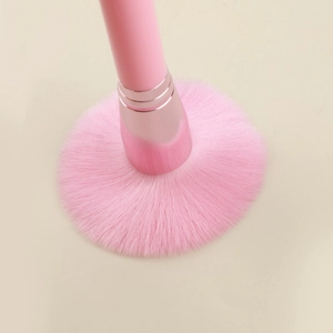 Gros plan sur les poils doux du pinceau poudre rose avec virole en métal rose