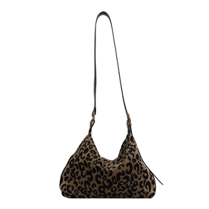 Large leopard print canvas hobo bag with black leather strap and gold hardware accents
