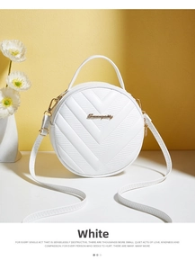 Detail of white V-quilted circular crossbody bag with gold logo and top handle