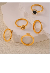Detailed set of five gold plated titanium rings with tree of life and heart designs
