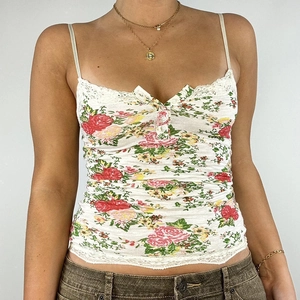 Close-up of floral camisole featuring lace trim and vintage rose pattern details