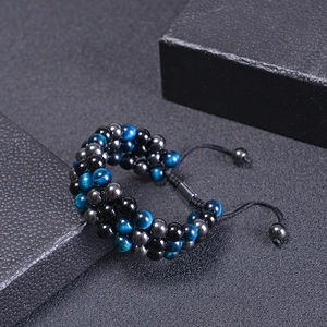 Three-layer tiger eye beaded bracelet with adjustable black woven cord on a gift box