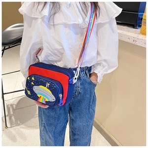 Kids crossbody bag with space UFO pattern and colorful rainbow strap shown on model