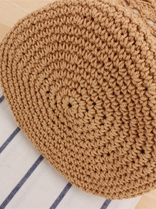 Handmade khaki woven cotton rope bag with dense spiral weave pattern for beach holidays