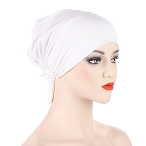 Detailed view of white pleated satin-lined undercap with adjustable back ties