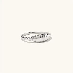 Macro shot of silver-colored twisted croissant ring with high-polished texture