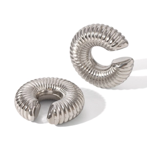 Detailed close-up of silver C-shaped ear cuffs with spiral scale texture on white background