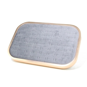 Close-up of rose gold jewelry tray with grey microfiber slots for rings and earrings