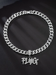 Close-up of silver Cuban link chain with iced out crystal PLUG pendant on black fabric