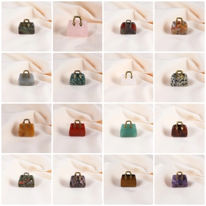 Variety of mini handbag pendants crafted from natural crystals with gold metal handles