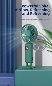 Detail view of portable mini fan with digital display and dark green folding design