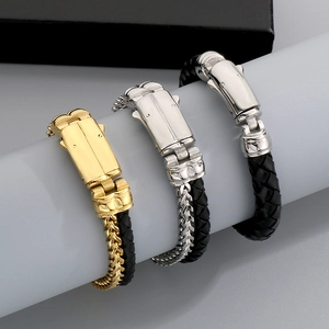Detail of woven black leather bracelets with gold and silver vacuum-plated metal clasps